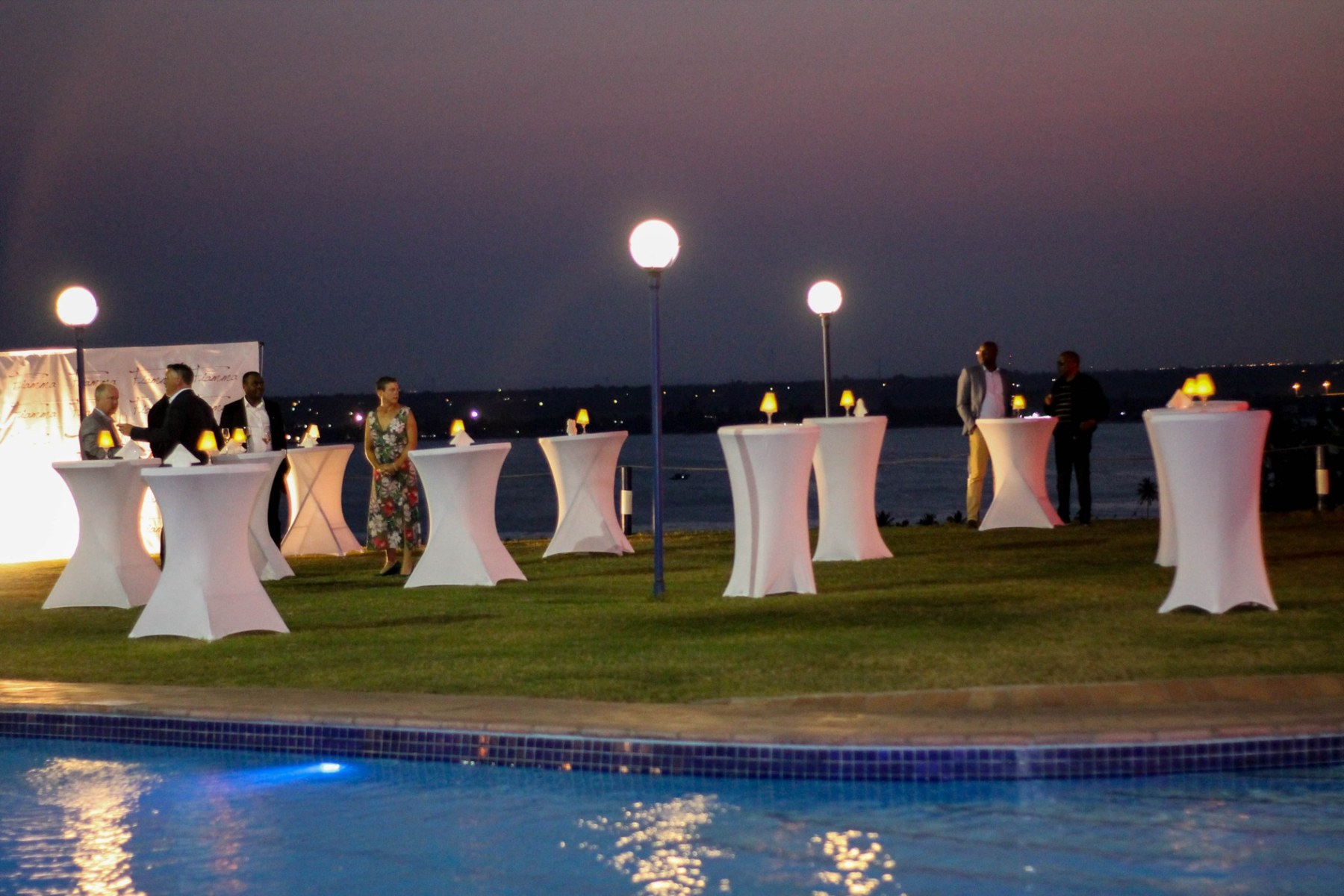 Evening cocktail event with a poolside setup